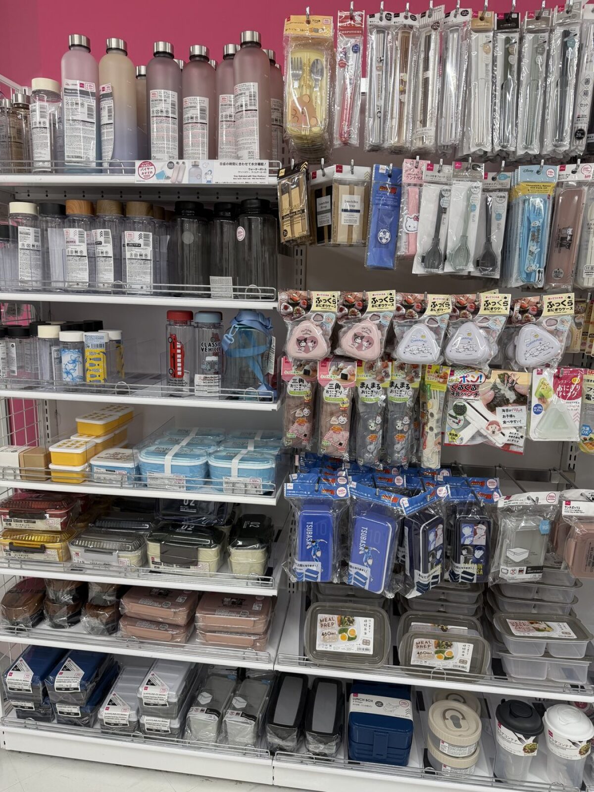 Shelves of bento boxes water bottles and chopstick sets at DAISO