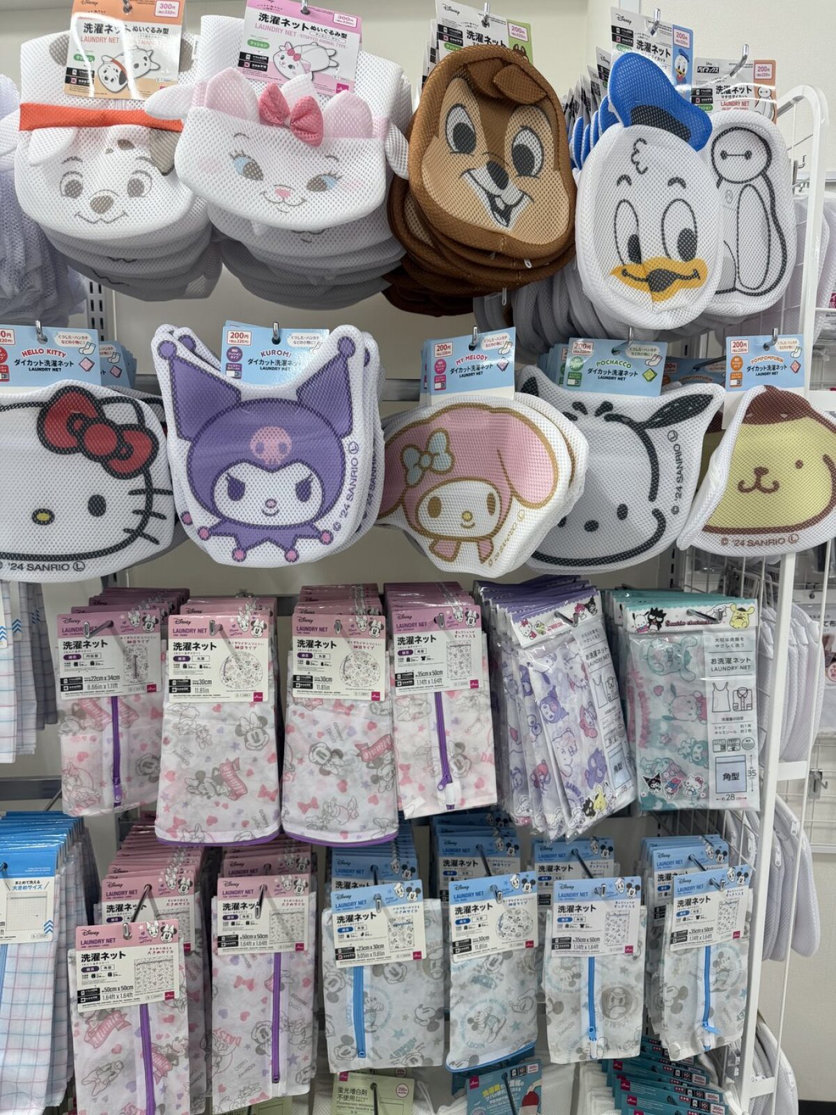 Wall of character-shaped laundry nets at DAISO featuring Sanrio and Disney characters