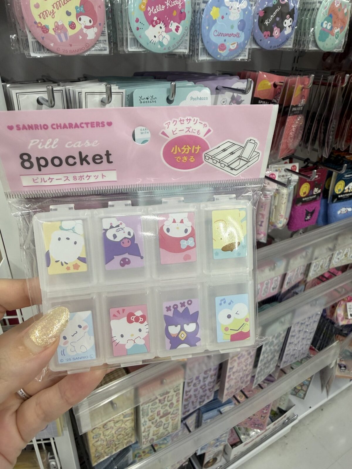 Sanrio character eight-pocket pill case held up in a DAISO aisle