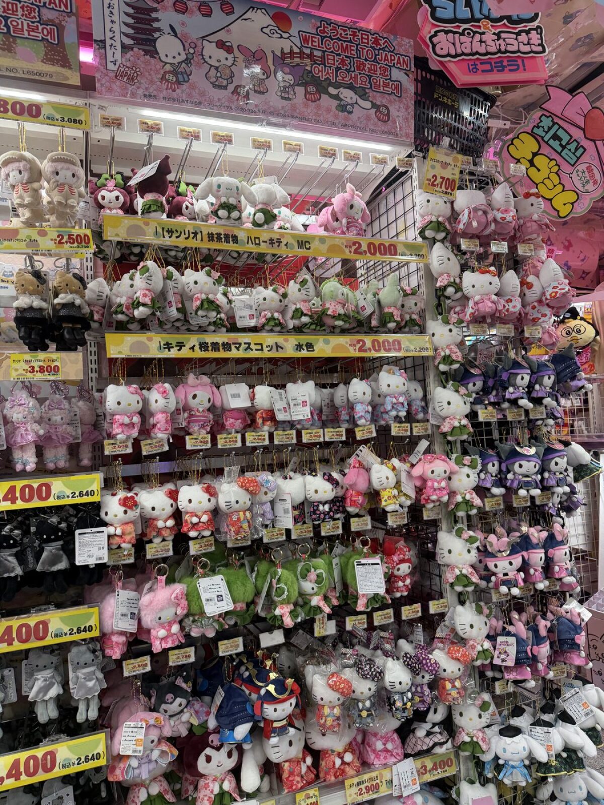 Floor to ceiling wall of Sanrio plush toys at Don Quijote