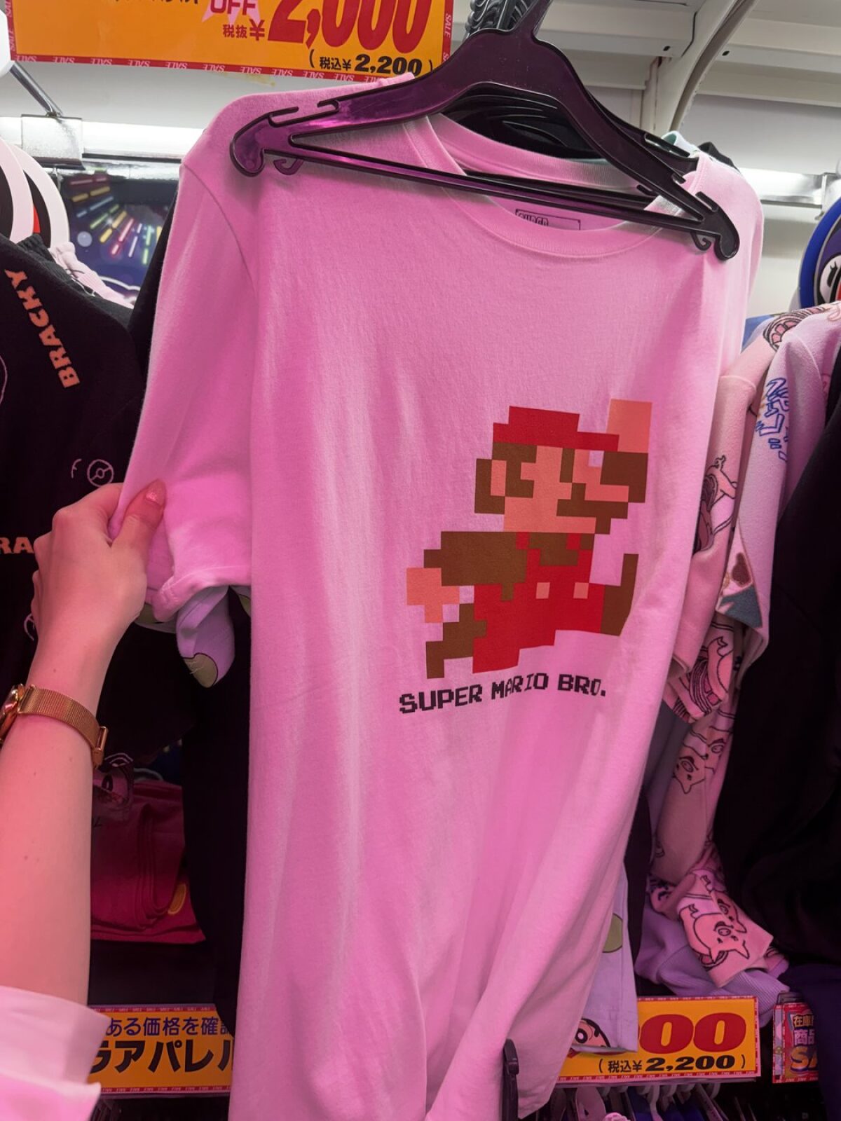 Pink Super Mario T-shirt on a clearance rack at Don Quijote