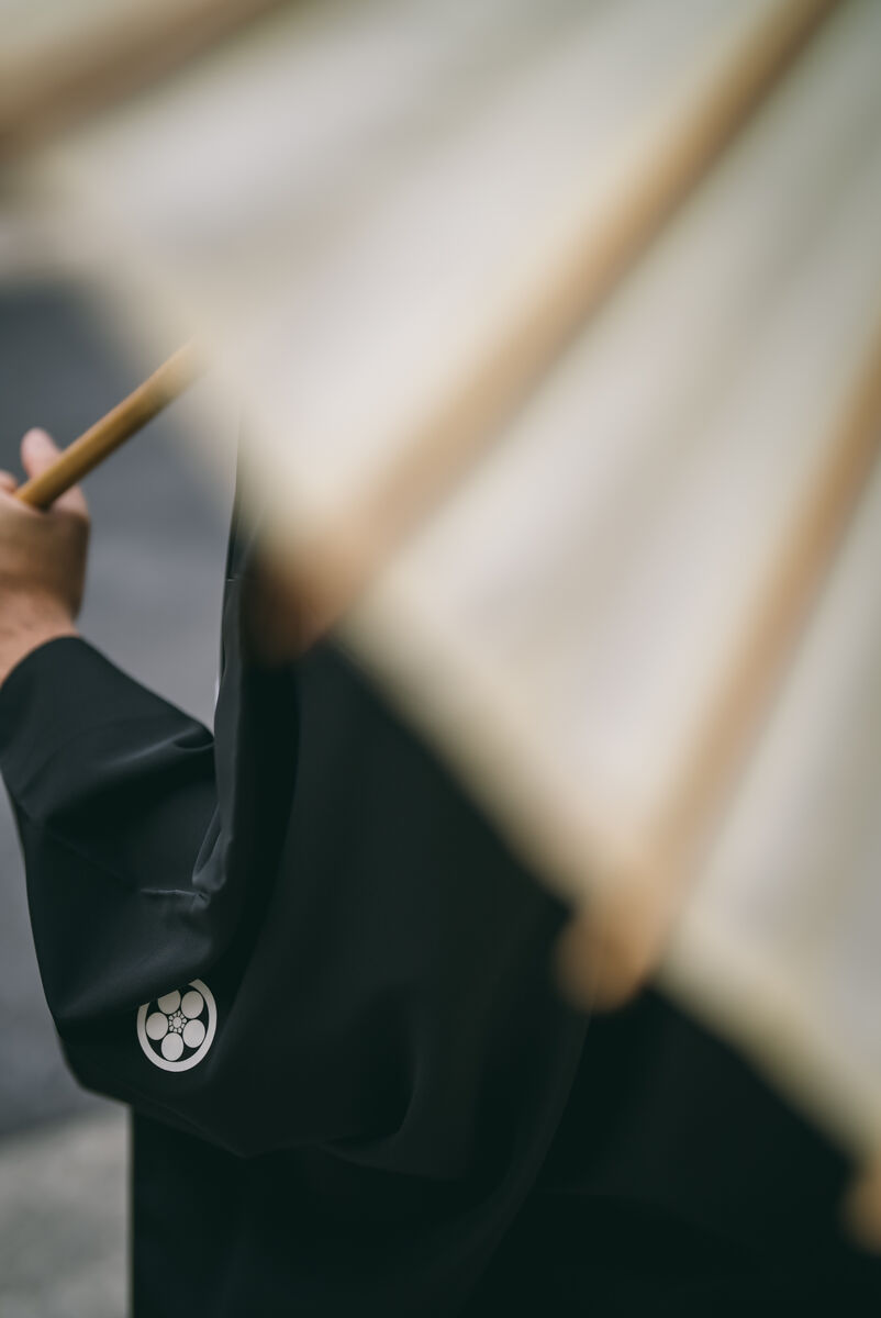 Family crest kamon on black montsuki kimono with Japanese umbrella