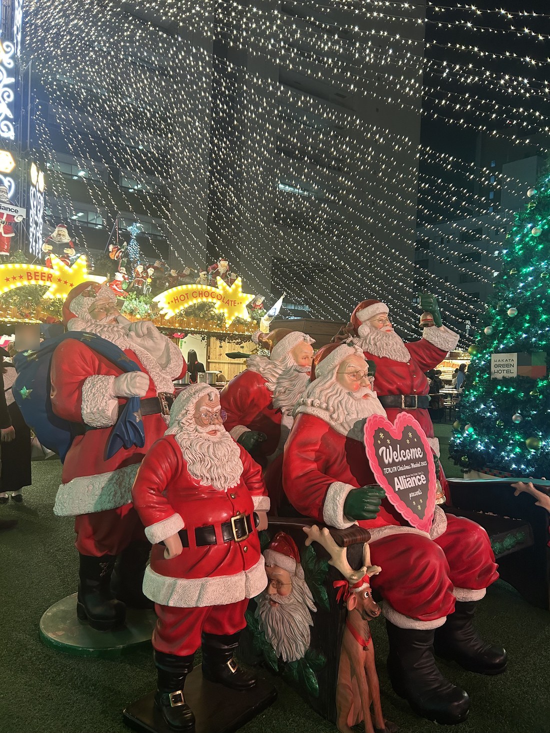 Santa Claus figures at a Japanese Christmas market at night