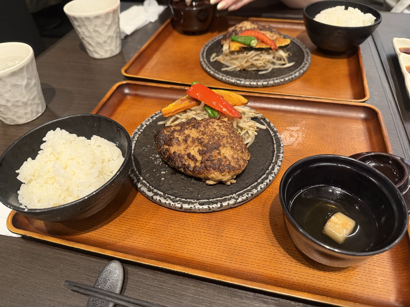 Hambagu teishoku set with rice bowl and miso soup on a wooden tray