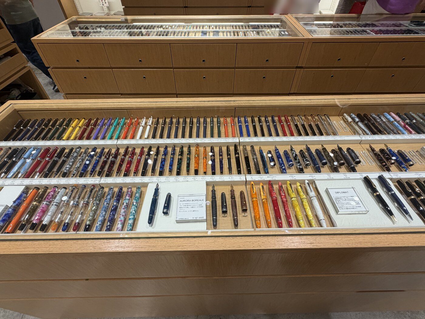 Fountain pen counter with rows of colorful pens at Itoya Ginza