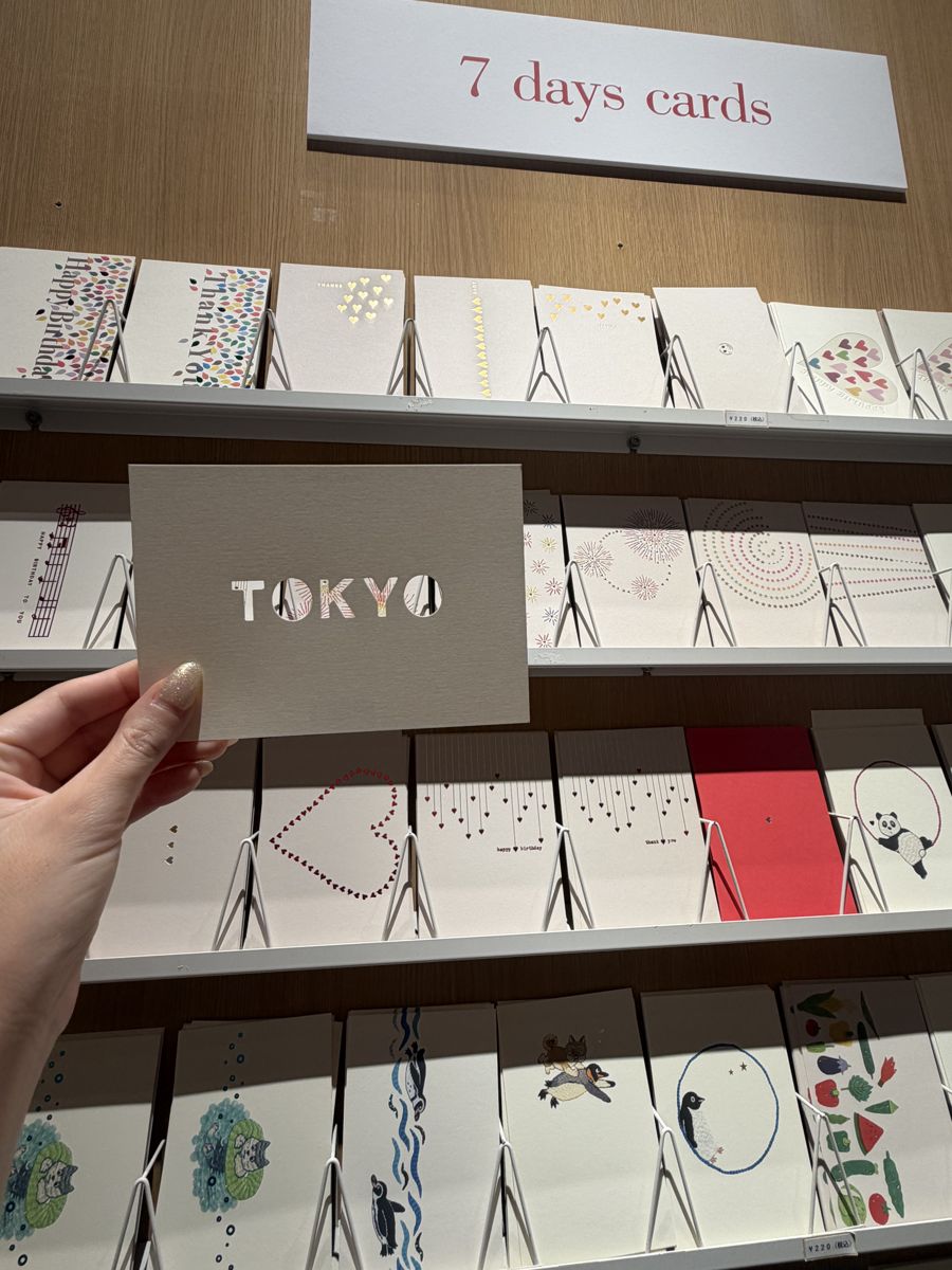 Hand holding a TOKYO die-cut card at Ginza Itoya