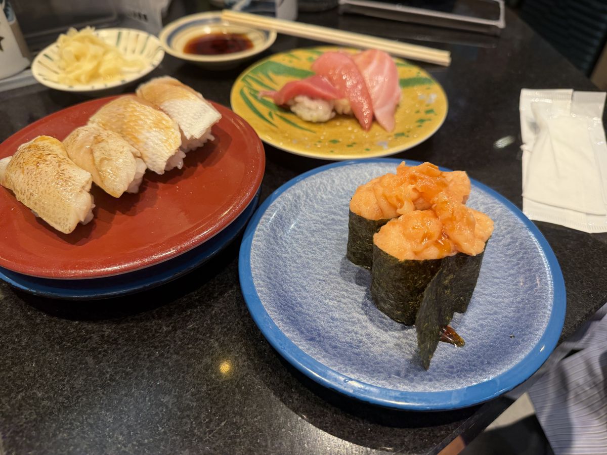 Aburi sushi and salmon gunkan plates at conveyor sushi restaurant