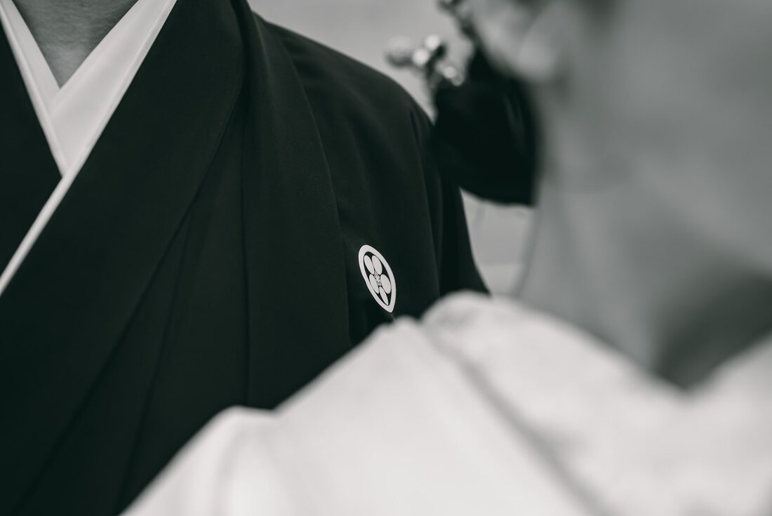 Black-and-white close-up of a family crest on a montsuki wedding haori