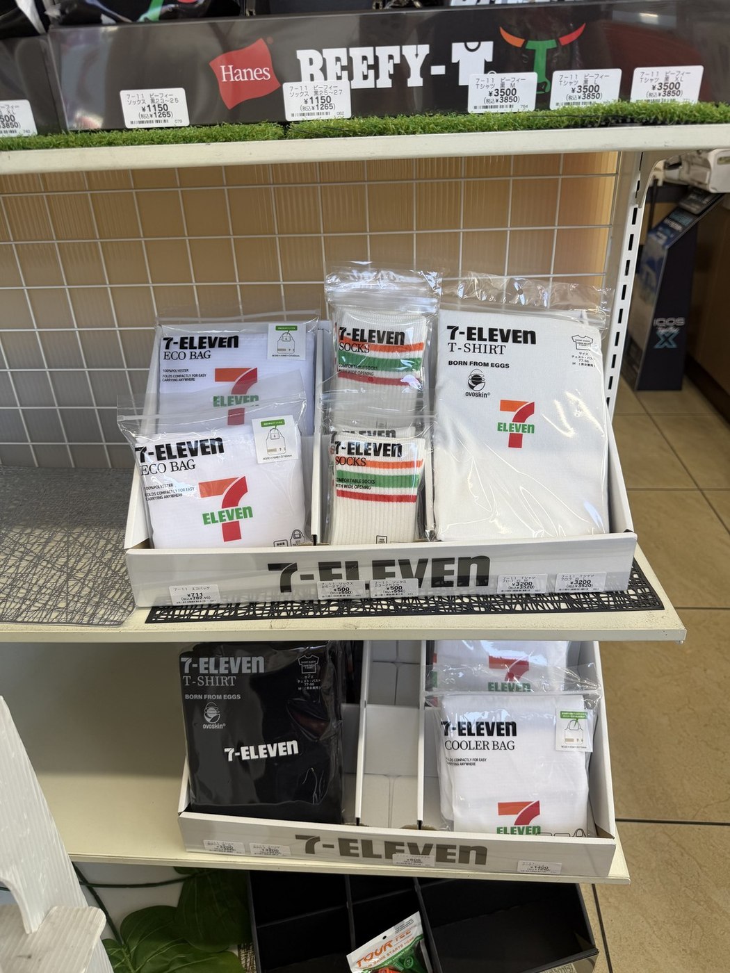 7-ELEVEN branded T-shirts, socks and eco bags on a shelf in a Japanese konbini