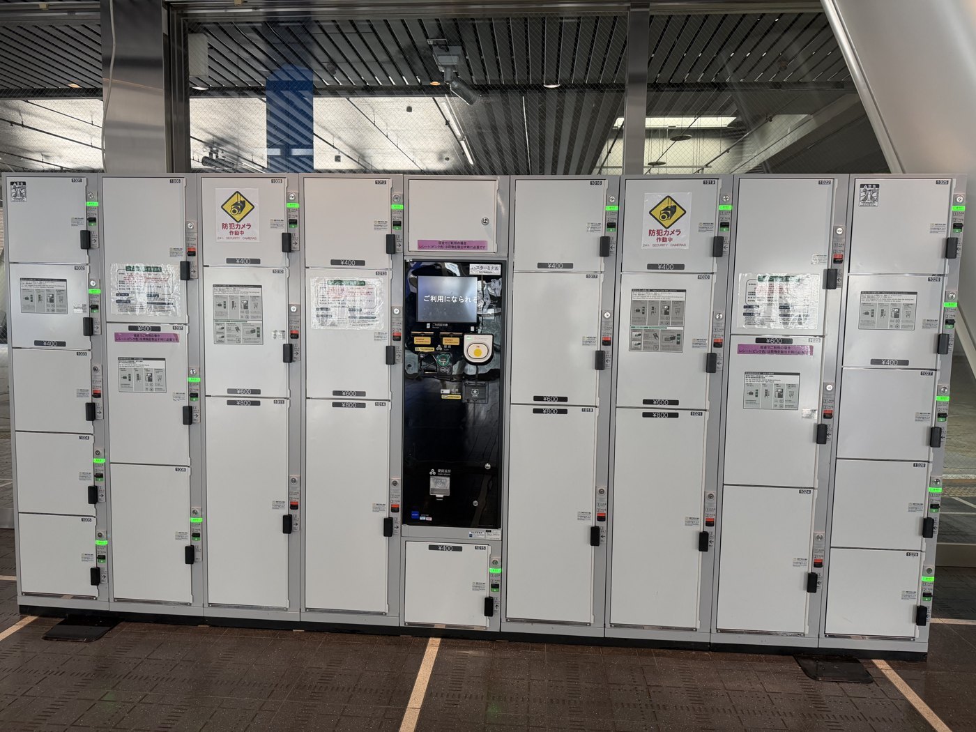 A bank of Japanese coin lockers with availability lights, at Oasis 21 in Nagoya