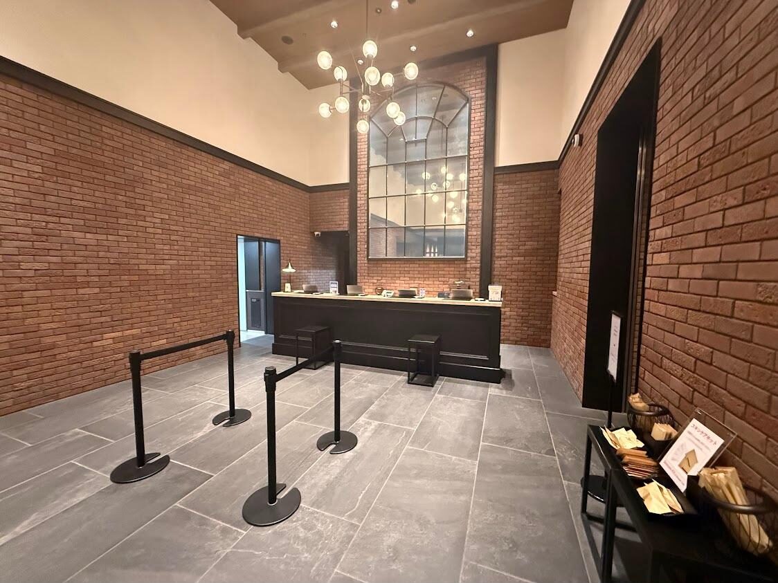 Brick-walled lobby and front desk at Citadines Harbour Front Yokohama