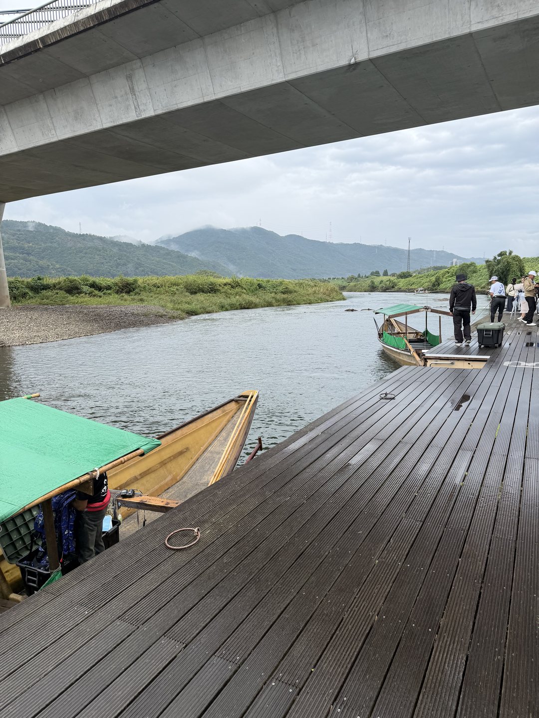 Hozugawa river boats with green rain canopies at the Kameoka boarding dock
