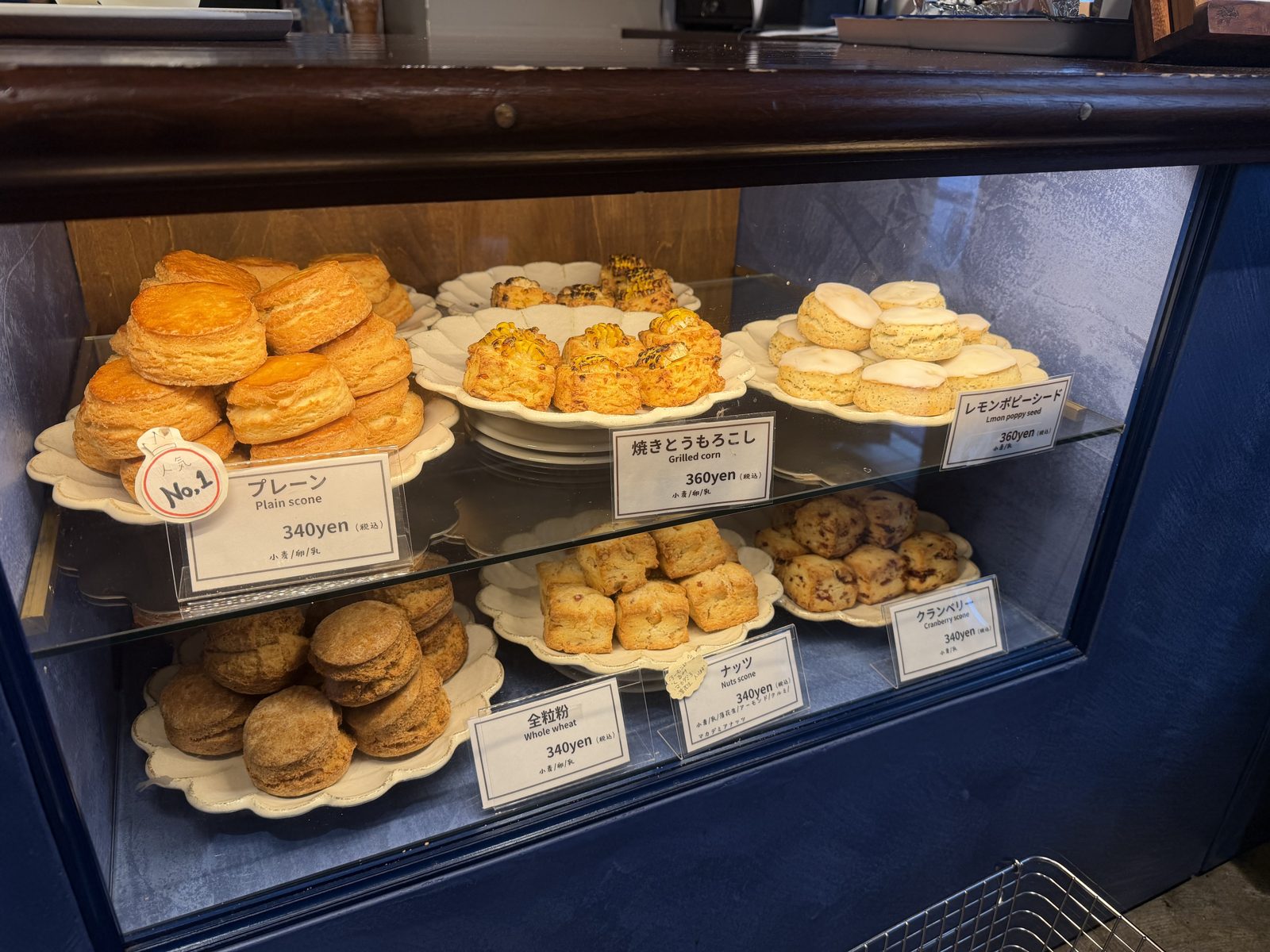 Scone display case at feb's coffee and scone Blucca in Kuramae with Japanese price tags, plain scone 340 yen, grilled corn 360 yen