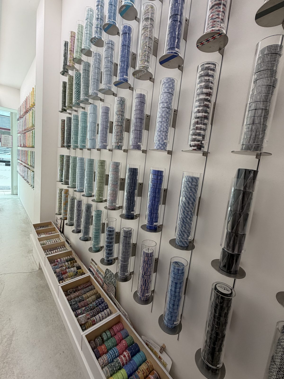 Wall of masking tape rolls in clear tubes at mt lab in Kuramae