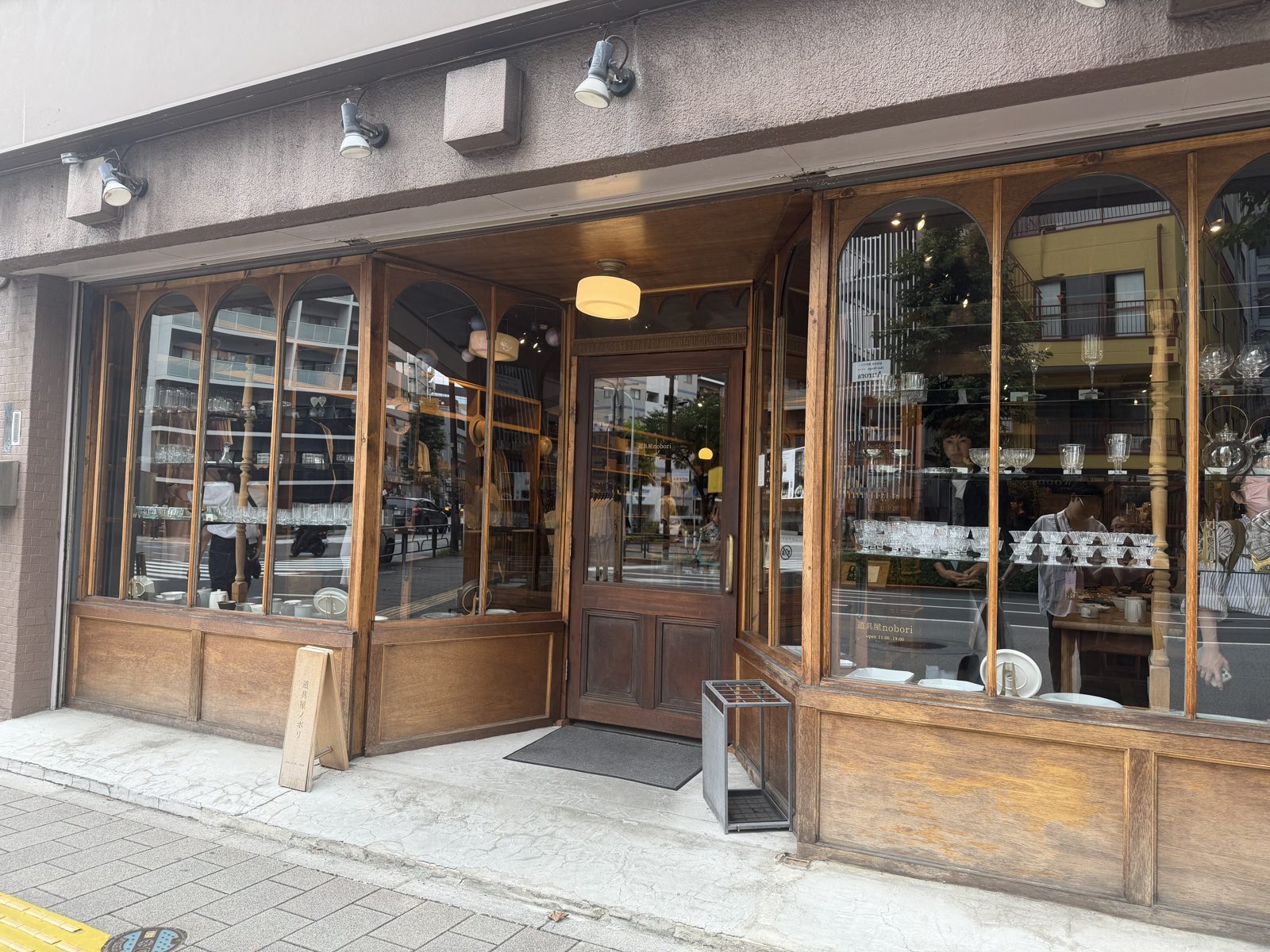 Wooden arched shopfront of Doguya nobori in Kuramae Tokyo with glassware in the windows