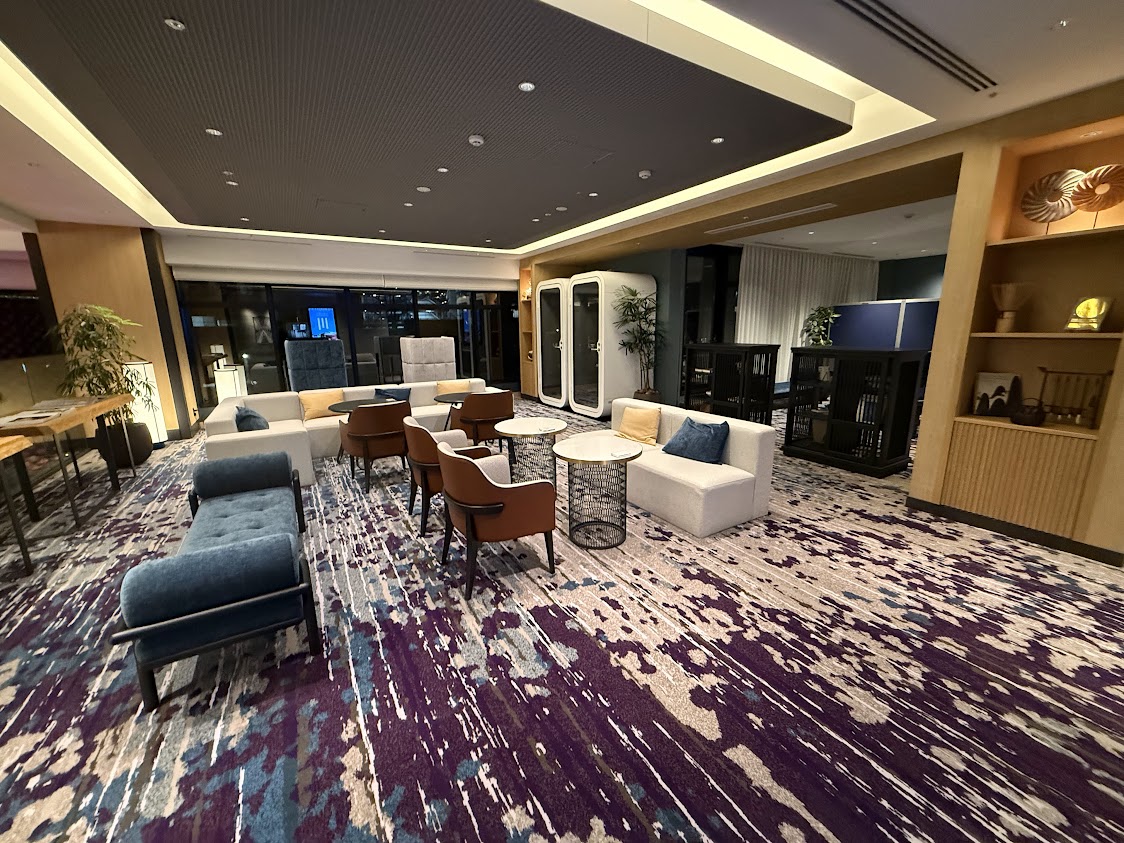 The lounge at Novotel Nara, with a long shared table and purple carpet