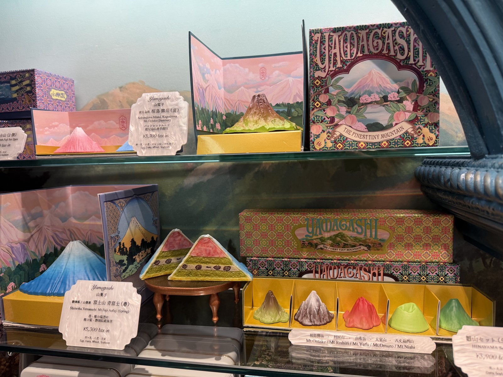 Shelves of mountain-shaped sweets in painted boxes with price tags